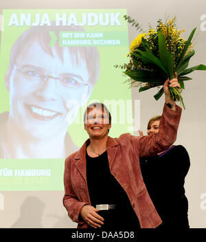 The top candidate of the Green Alternative list GAL for the advanced vote of Hamburg's cizisens, Anja Hajduk, cheers with a bouquet of flowers after her nomination during a party meeting of GAL in Hamburg, Germany, 8 January 2011. Hamburg's Green Party are led into the election campaign by Hajduk. The 47-year-old was elected top candidate for the vote on 20 February 2011 by a vast  Stock Photo