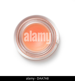 orangy pink lip gloss balm blush pot cut out onto a white background Stock Photo