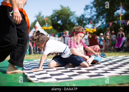 Children take part in a sock wrestling competition in the kids field on ...