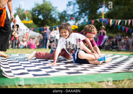 Children take part in a sock wrestling competition in the kids field on ...