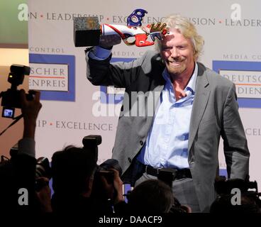 British enterpriser and billionaire Richard Branson is awarded with the German Media Prize 2010 at the Congress Center of Baden Baden, Germany, 24 January 2011. Despite his cruciate ligament rupture, he showed up on crutches to receive his prize. Since 1992, the German Media Prize is awarded to a public figure, who has, according to the view of the chief editors in the selection co Stock Photo