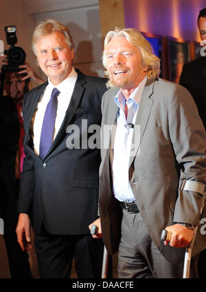 British enterpriser and billionaire Richard Branson is awarded with the German Media Prize 2010 at the Congress Center of Baden Baden, Germany, 24 January 2011. Despite his cruciate ligament rupture, he showed up on crutches to receive his prize. To his left stands media entrepreneur Karlheinz Koegel who founded the prize. Since 1992, the German Media Prize is awarded to a public f Stock Photo