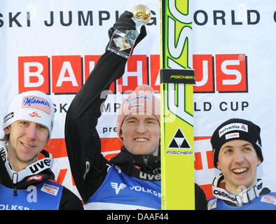 Second placed Simon Ammann of Switzerland, right, congratulates