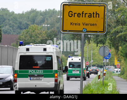 A file picture taken on 7 September 2010 shows police cars next to the town's gateway sign in Grefrath, Germany. The ten-year-old boy Mirco is still missing. Now, a suspect has been arrested on 27 January 2011. The man is suspected to be involved in the disappearance of Mirco five months ago. Photo: Rene Tillmann Stock Photo