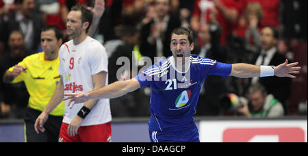 Michael Guigou (R) of France celebrates after scoring against Lars Christiansen of Denmark during the final of the Men's Handball World Championship semi-final match France against Sweden in Malmo, Sweden, 28 January 2011. France clinched their fourth title defeating Denmark 37-35 a.e.t. Photo: Jens Wolf Stock Photo