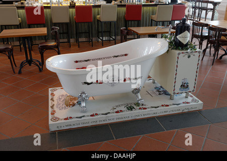 Classic roll top bath with Hendricks Gin dispenser as tap in a Raffles bar, Singapore Stock Photo