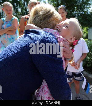 Keila, Estonia, 09 July 2013. Partner of the German President Daniela Schadt holds a child during a visit to the SOS Children's Village in Keila, Estonia, 09 July 2013. Photo: WOLFGANG KUMM/dpa/Alamy Live News Stock Photo