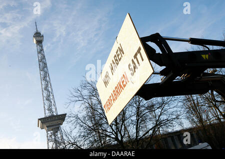 A poster with the caption 'We are fed up with animal factories' hangs at the trade show grounds on a tractor during the Green Week in Berlin, Germany, 22 January 2011. About 70 farmers have come together to demonstrate and to hand in a note of protest to the state secretary of the German Ministry of Agriculture. Photo: Florian Schuh Stock Photo