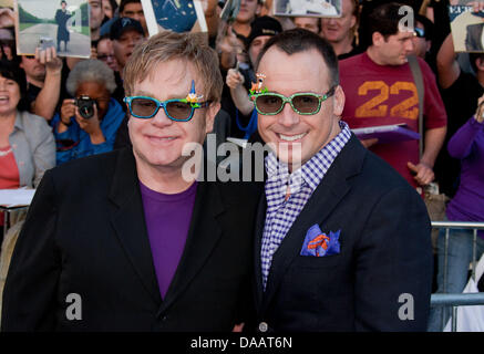 British musician Elton John (L) and his husband David Furnish (R) arrive at the world premiere of the film 'Gnomeo And Juliet' in Los Angeles, USA, 23 January 2011. Photo: Hubert Boesl Stock Photo