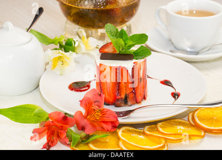 dessert, a piece of cake on the table with a cup of tea Stock Photo