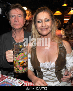 Actor Juergen Prochnow and his partner Birgit Stein celebrate at the celebrity regular's table of Birgitt Wolff and Sepp Kraetz at the Oktoberfest 2011 in Munich, Germany, 17 September 2011. The 178th Oktoberfest attracts visitors from all over the world to join the festival in the Bavarian capital until 03 October 2011. Photo: Ursula Dueren Stock Photo