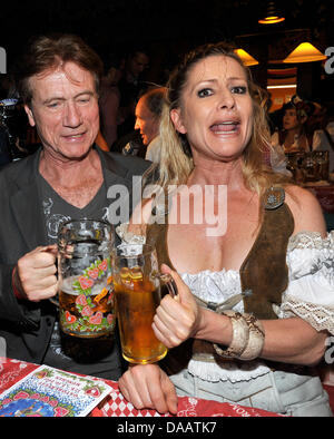 Actor Juergen Prochnow and his partner Birgit Stein celebrate at the celebrity regular's table of Birgitt Wolff and Sepp Kraetz at the Oktoberfest 2011 in Munich, Germany, 17 September 2011. The 178th Oktoberfest attracts visitors from all over the world to join the festival in the Bavarian capital until 03 October 2011. Photo: Ursula Dueren Stock Photo