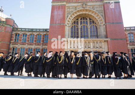 Students lining up after a graduation ceremony at Birmingham University, UK, to have their photograph taken. Stock Photo