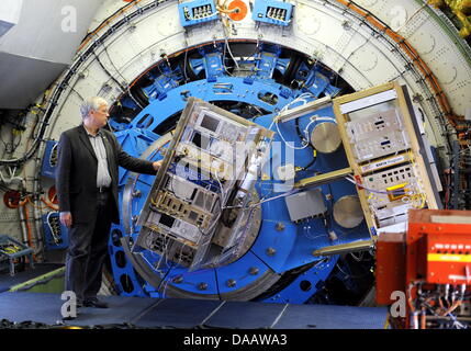 Juergen Stutzki of the University of Cologne, stands next to a spectrometer inside the world's only flying observatory, a German-American stratosphere observatory, at the airport in Stuttgart, Germany, 19 September 2011. During the next 20 years and several times a week, the stratosphere observatory for infrared astronomy (Sofia) is to send novel galactic images out of a Boeing 747 Stock Photo