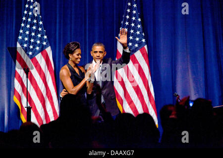 First lady Michelle Obama applauds United States President Barack Obama at a Democratic National Committee (DNC) fundraiser in midtown, Manhattan, New York on Tuesday, September 20, 2011.  Photo: Allan Tannenbaum Stock Photo
