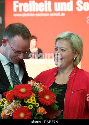 The old and new The Left party president, Matthias Hoehn, congratulates Gesine Loetzsch, federal president of The Left party at the state party conference in Saxony-Anhalt in Madgeburg, Germany, 24 September 2011. The Left party is electing a new state executive board in Saxony-Anhalt today. Sole candidate for the top position is the current party leader Matthias Hoehn. A further t Stock Photo
