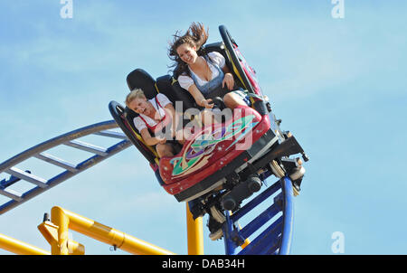 Kerstin and Anna enjoy a ride in the rollercoaster at the Canstatt Wasen in Stuttgart, Germany, 25 September 2011. Around one million people have visited the festival so far due to the fine weather. Photo: FRANZISKA KRAUFMANN Stock Photo