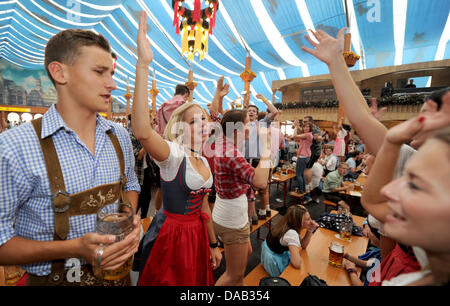 Visitors celebrate inside a party tent at the Canstatt Wasen in Stuttgart, Germany, 25 September 2011. Around one million people have visited the festival so far due to the fine weather. Photo: FRANZISKA KRAUFMANN Stock Photo