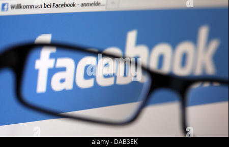 The ILLUSTRATION shows the Facebook logo seen through the lens of a pair of glasses in Cologne, Germany, 8 September 2011. Photo: Oliver Berg Stock Photo