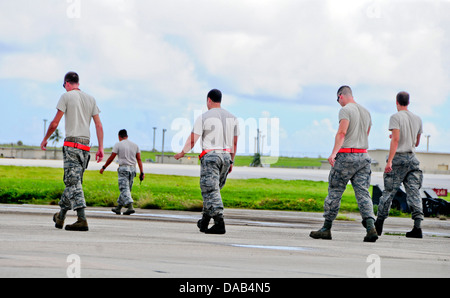Airmen from the 36th Expeditionary Aircraft Maintenance Squadron checks for foreign object debris after conducting maintenance and launching a B-52 Stratofortress July 2, 2013, on the Andersen Air Force Base, Guam, flightline. Members of the 36th EAMXS ar Stock Photo
