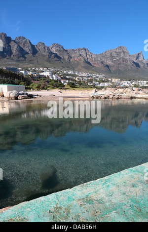 View of the tidal pool and Twelve Apostles (Table Mountain range) from Camps Bay beach, Western Cape Province, South Africa Stock Photo