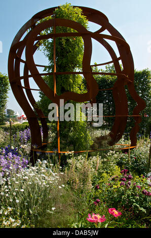 Hampton Court, UK. 8th July 2013. Cotton Steel head sculpture in the McCarthy & Stone Garden at RHS Hampton Court Palace Flower Show 2013 on Press Day, Monday 8th July 2013 in London, UK. The Gold medal winning garden was designed by Chris Beardshaw and sponsored by retirement property developer McCarthy & Stone Credit:  Miriam Heppell/Alamy Live News Stock Photo