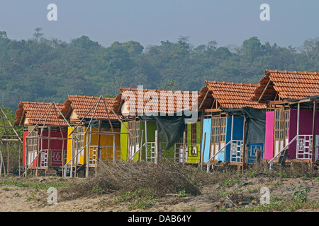 Cocohut beach holiday bungalows on stilts Agonda beach, Goa India Stock Photo