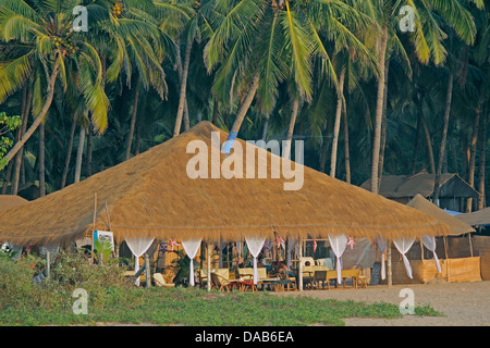 Cocohut beach holiday bungalows on stilts Agonda beach, Goa India Stock Photo