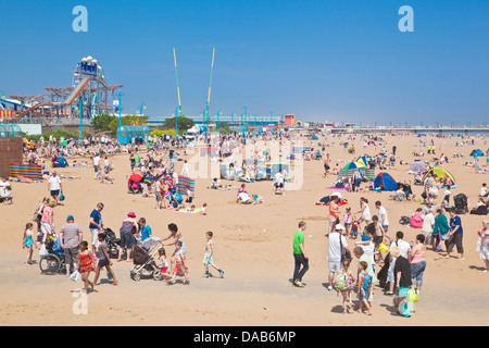 crowded busy Skegness Beach and pleasure beach amusement park Skegness Lincolnshire england UK GB EU Europe Stock Photo