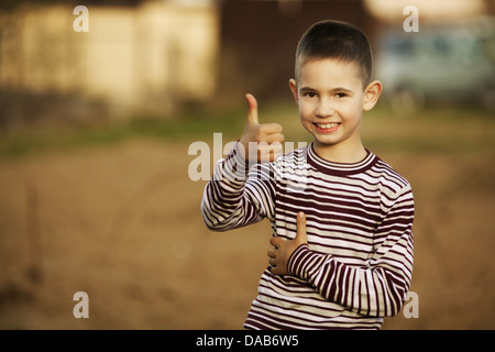 little boy shows thumbs up gesture Stock Photo