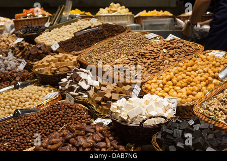 Nuts, candies and dried fruits for sale at La Boqueria Market - Barcelona, Catalonia, Spain Stock Photo