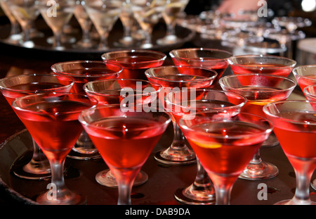 Close up of a tray of brightly colored Cosmopolitan Martinis with lemon garnish Stock Photo