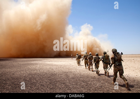 US Marines and Georgian soldiers assigned to the 33rd Light Infantry Battalion make their way to the helicopter extraction point during Operation Northern Lion II July 3, 2013 in Helmand province, Afghanistan. Stock Photo