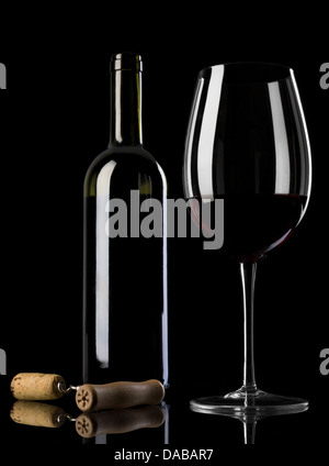 a bottle of red wine with a glass half full and the cork twisted in the corkscrew Stock Photo