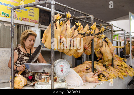 Butcher meat meats chicken poultry shop stand stall shopping in local central market marketplace in Chiclayo, Peru. Stock Photo