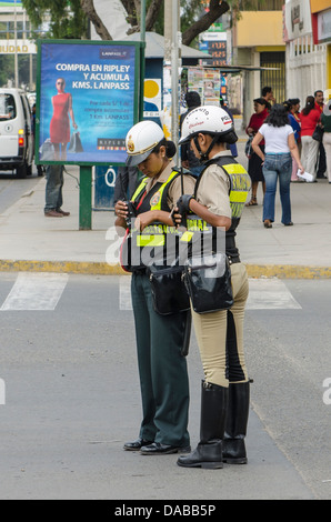 Police women patrolling directing traffic on the street in Chiclayo, Peru. Stock Photo