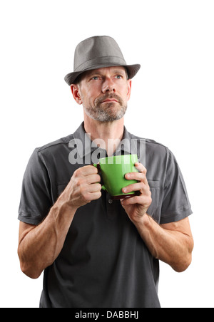 A portrait of a 40-something male wearing a fedora, holding a cup of coffee and looking up, isolated on white. Stock Photo