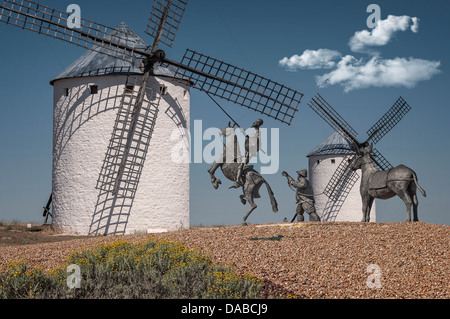 Windmill and statue of Don Quixote on his horse Rocinante and Sancho Panza in Campo de Criptana, Castilla la Mancha, Spain. Stock Photo