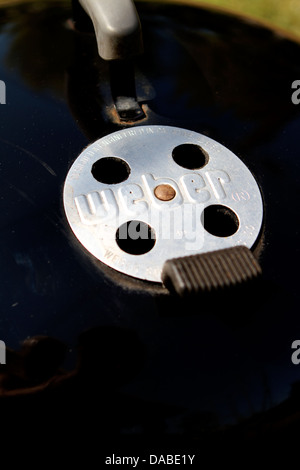 the heat vent on a weber outdoor barbecue Stock Photo