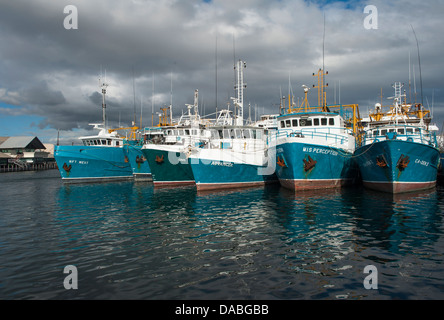 Fishing trawlers at the Fremantle Fishing Boat Harbour, Western Australia, with rainy showers approaching Stock Photo