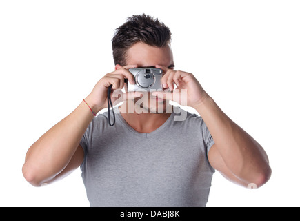 Attractive young man taking picture with compact photo camera Stock Photo
