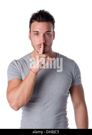 Hush. Young man silencing you, saying shut Stock Photo