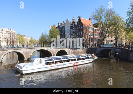 Tourist boat crossing Keizersgracht Canal, Amsterdam, Netherlands, Europe Stock Photo