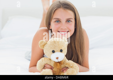 Cute young girl holding a teddy bear Stock Photo