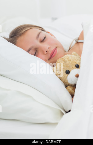 Cute girl sleeping with her teddy bear in her bed Stock Photo - Alamy