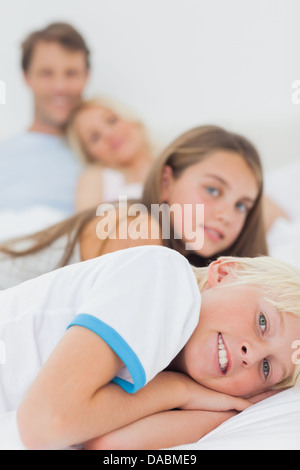 Children resting in the bed of their parents Stock Photo