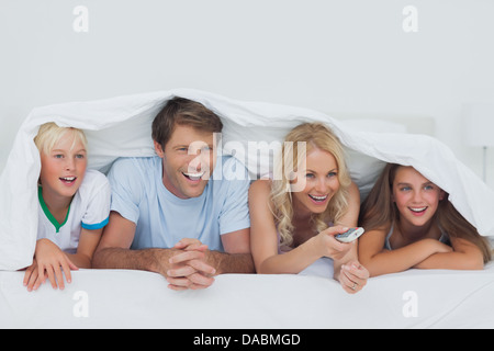 Smiling family watching TV