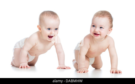 Smiling babies girl and boy crawling on floor Stock Photo