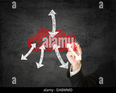Businessman drawing cloud with in and outgoing arrows Stock Photo