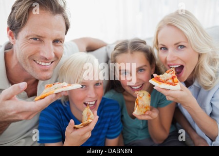 Smiling family eating pizza Stock Photo